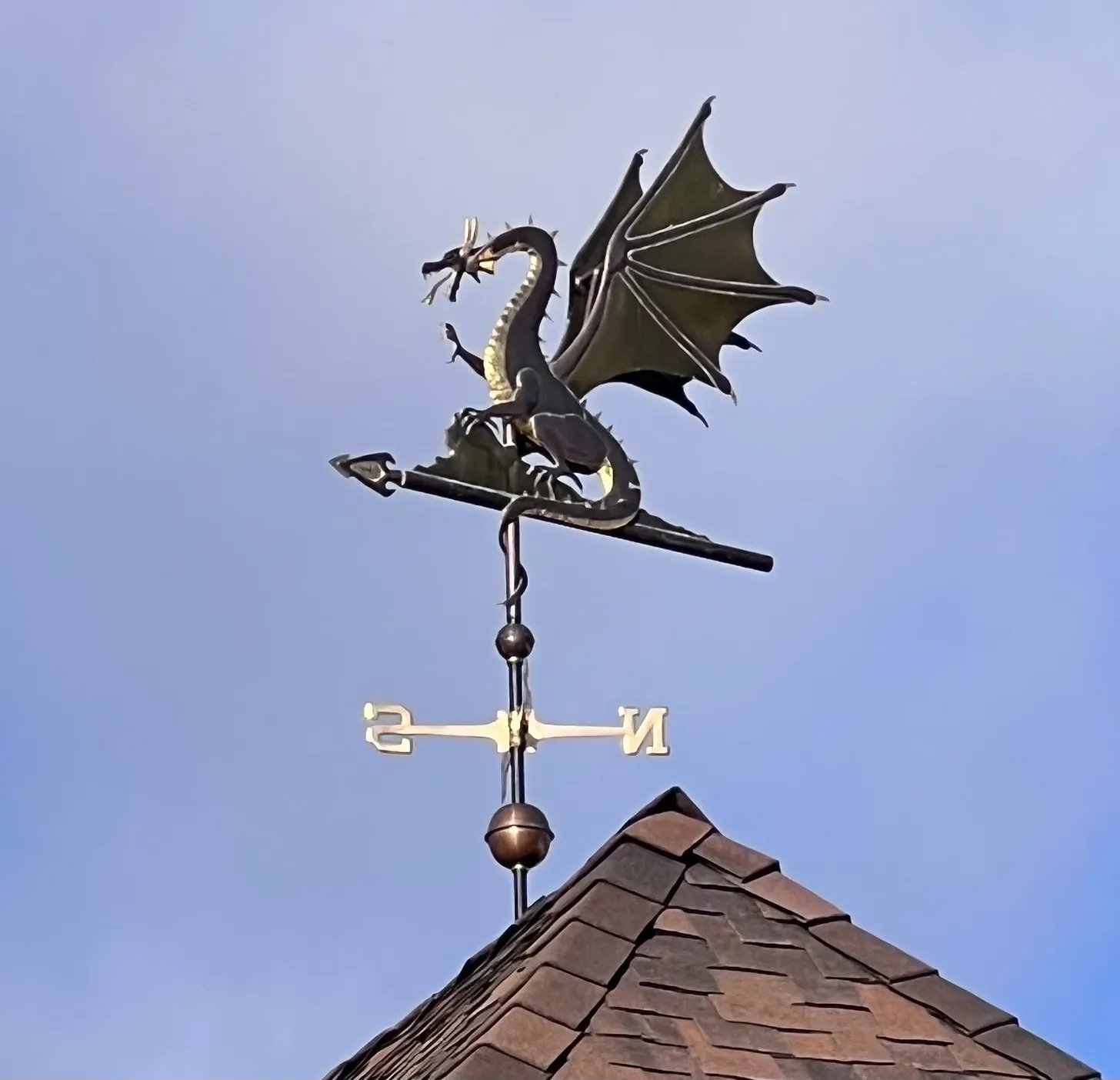 A dragon weathervane against the sky